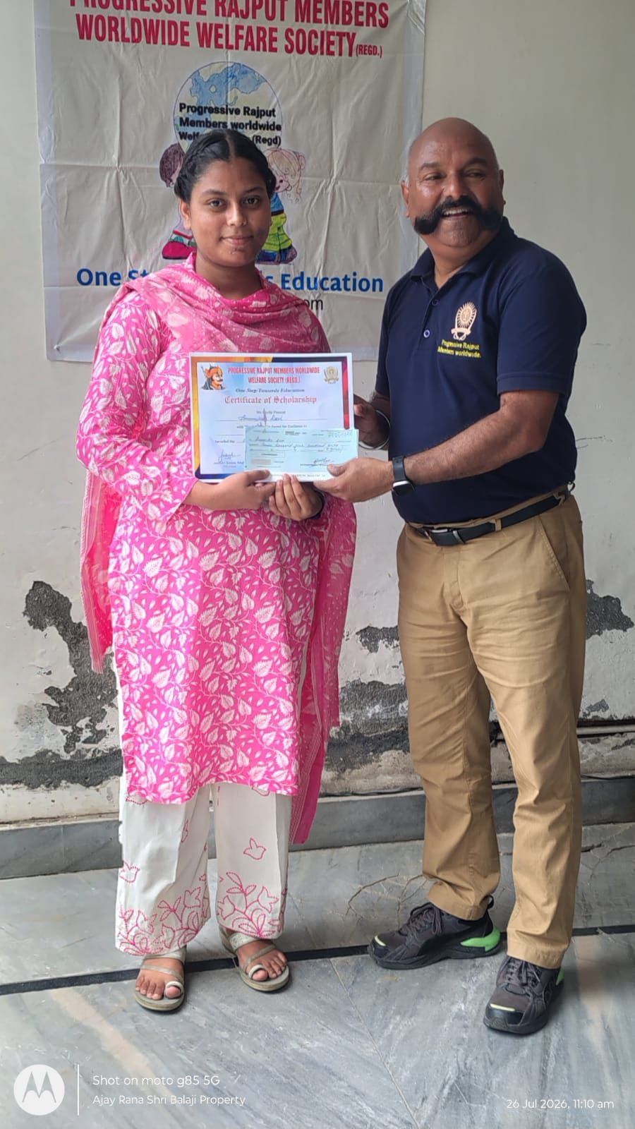 A student receiving her scholarship certificate