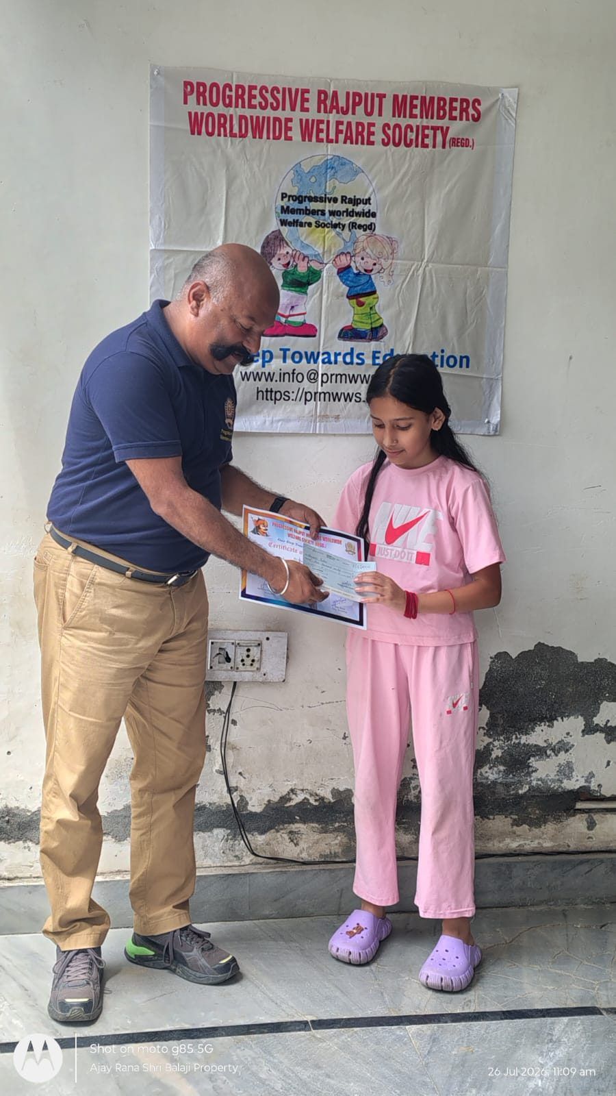 A student reading her scholarship certificate